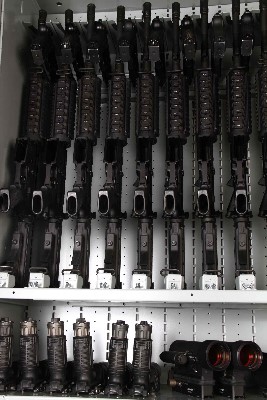 M4 Rifles stored with M9 pistols and NVGs inside Combat Weapon Racks